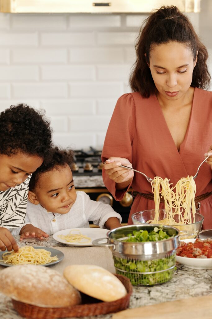 Woman serving kids dinner to show that all foods fit