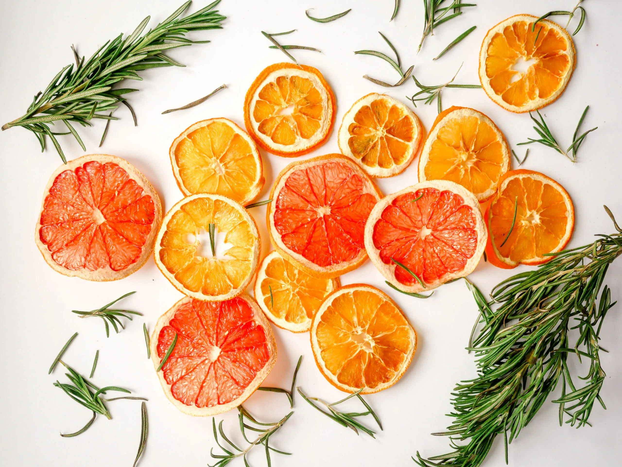 Brightly colored citrus fruit with rosemary