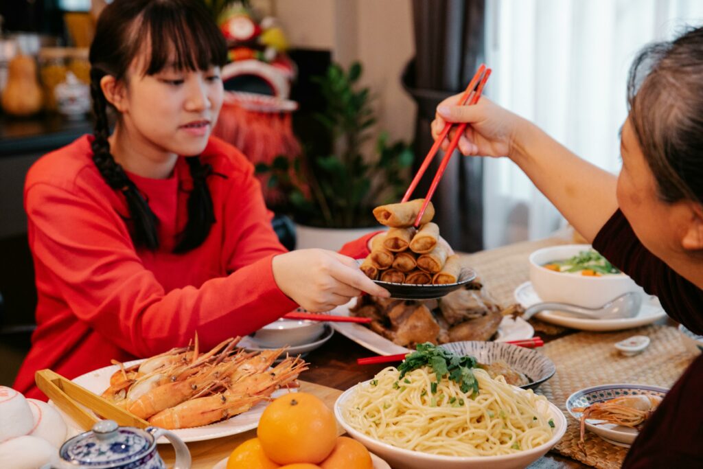 Asian girl eating dinner with family