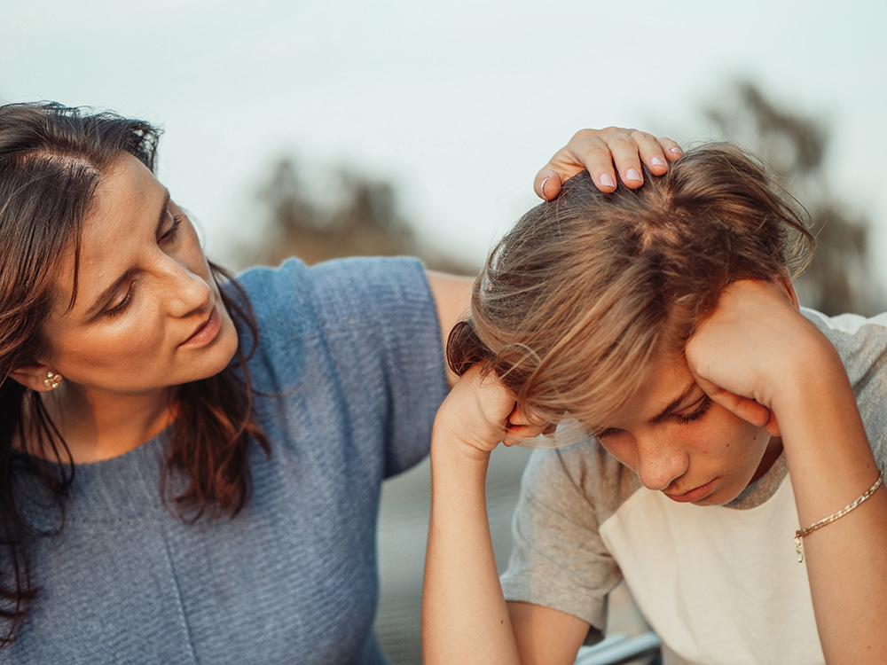 Mother comforting child about body image concerns.
