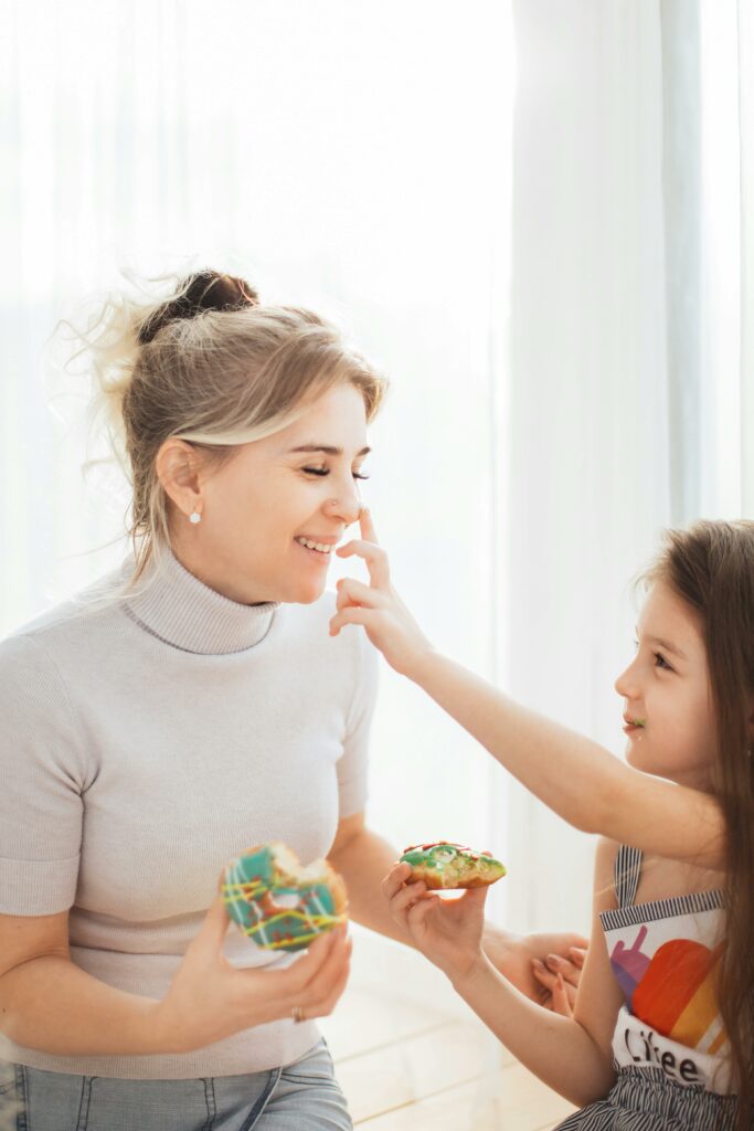 Parent enjoying donut with child and modeling mindful eating for kids