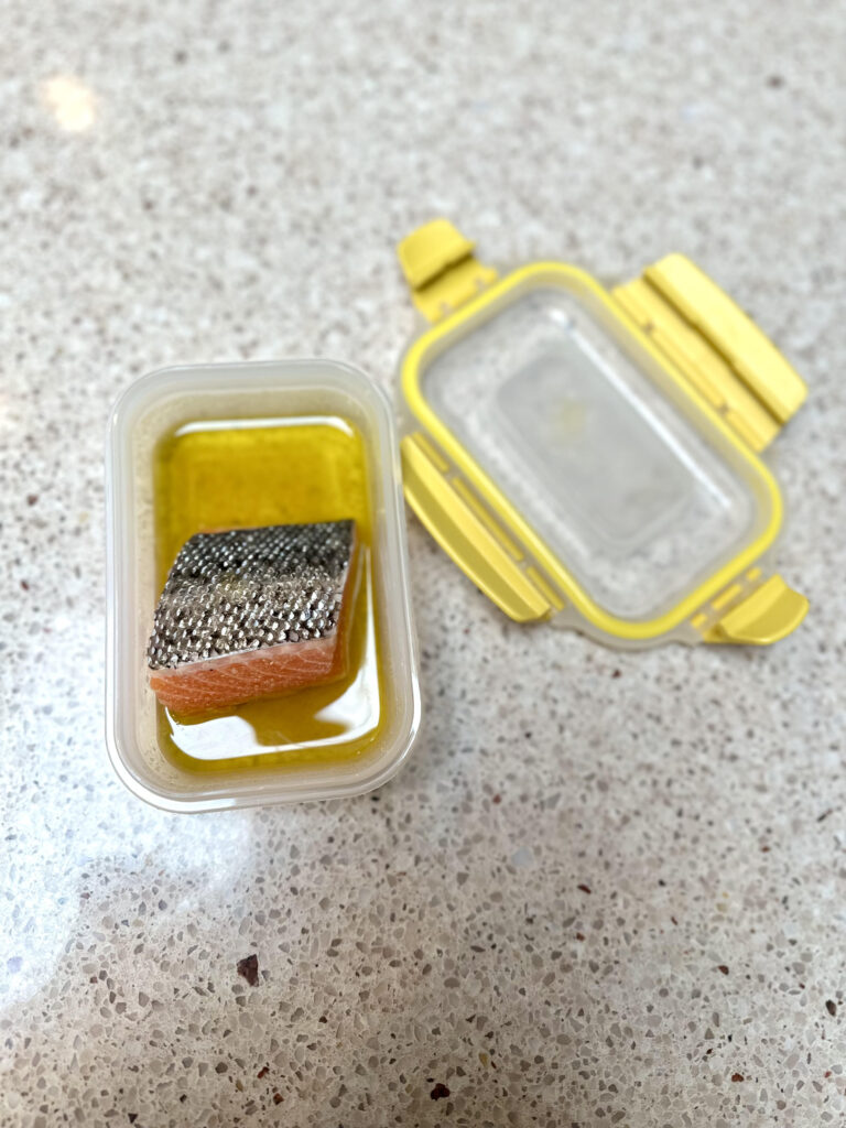 kids salmon marinated without lemon in a small tupperware